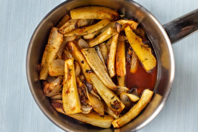 Roasted parsnips in a saucepan.