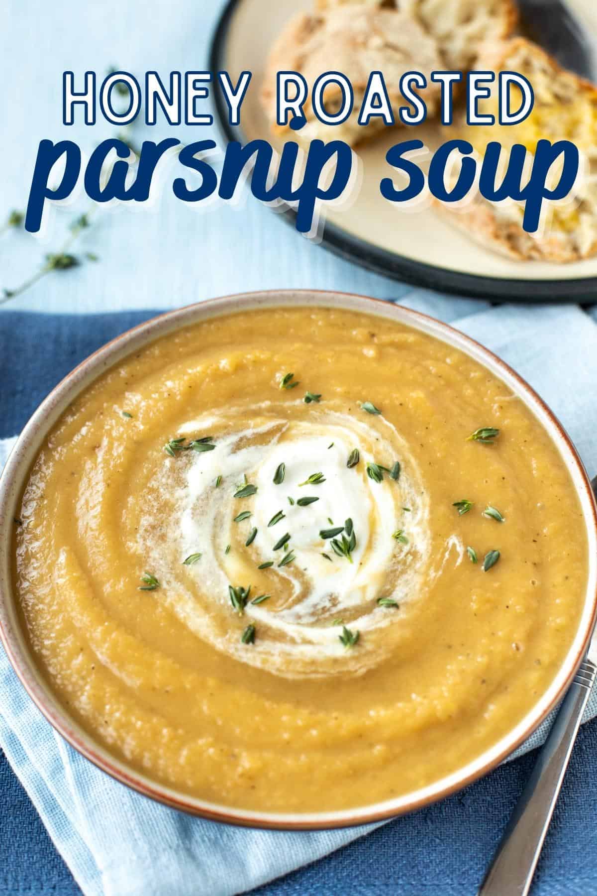 A bowl of creamy parsnip soup topped with a swirl of cream and fresh thyme.