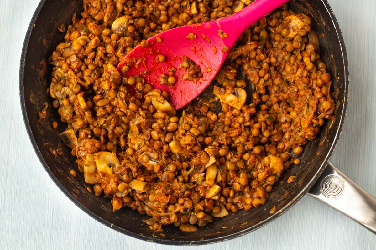 Chipotle lentils cooking in a frying pan.