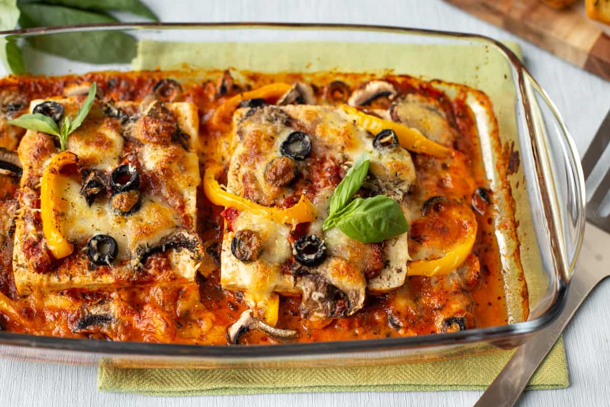 A dish of pizza baked tofu with crispy cheese.