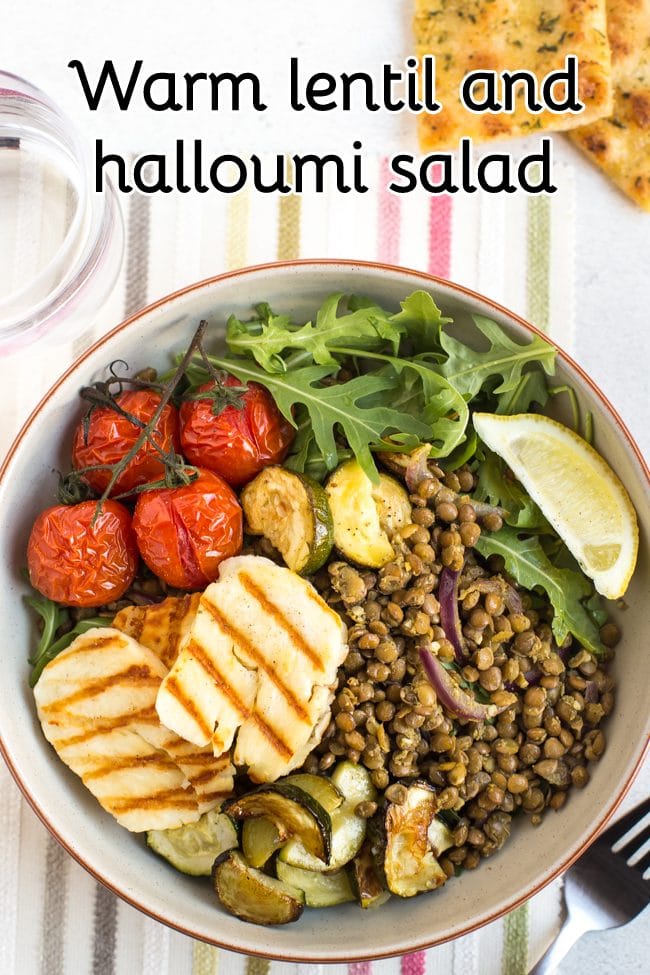 Warm lentil and halloumi salad in a bowl with roasted tomatoes