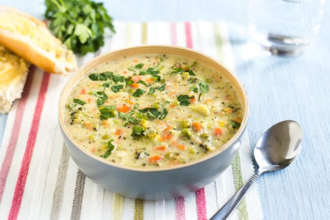 Portion of creamy veggie pot pie soup topped with parsley