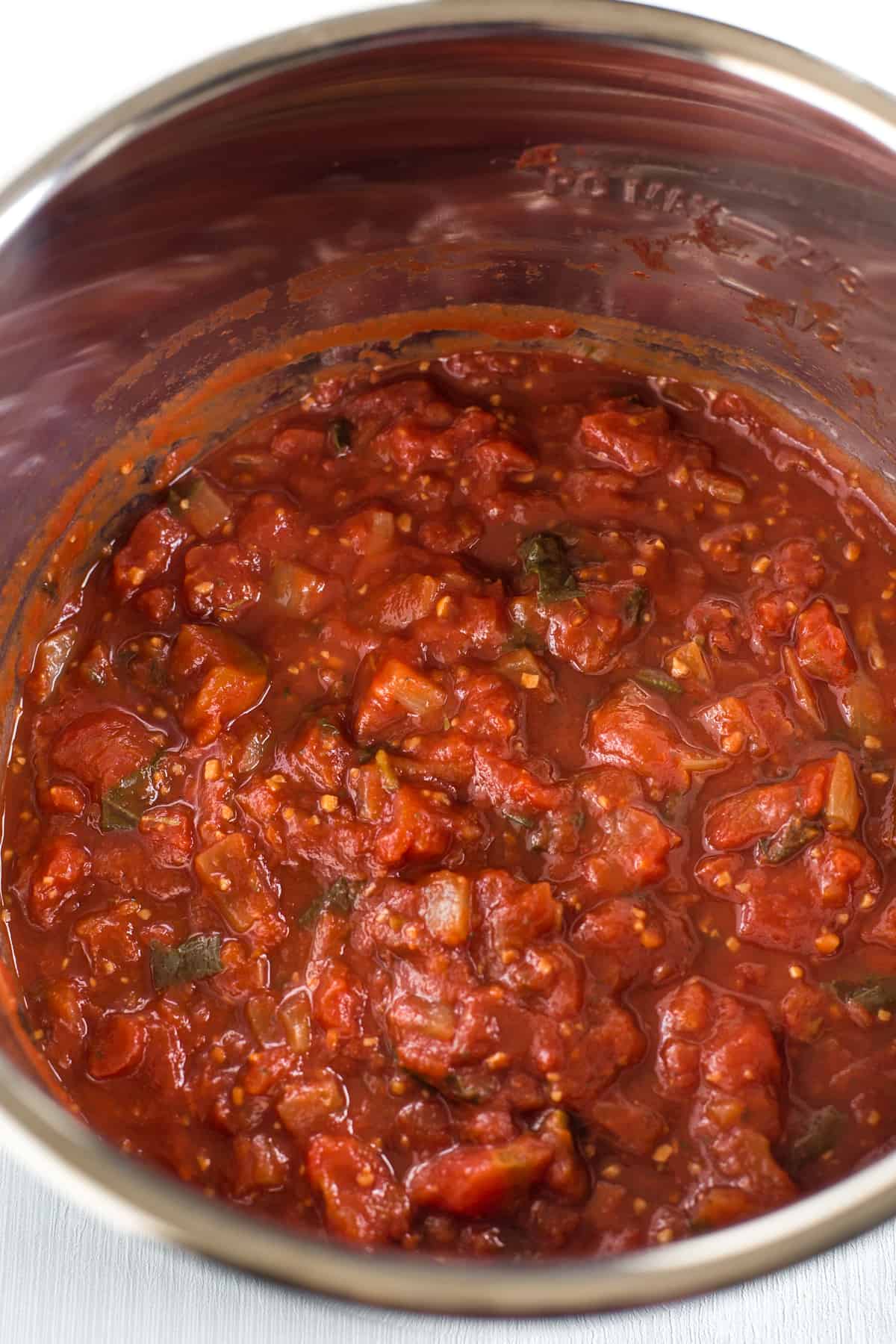 Chunky slow cooker tomato sauce in the pot.