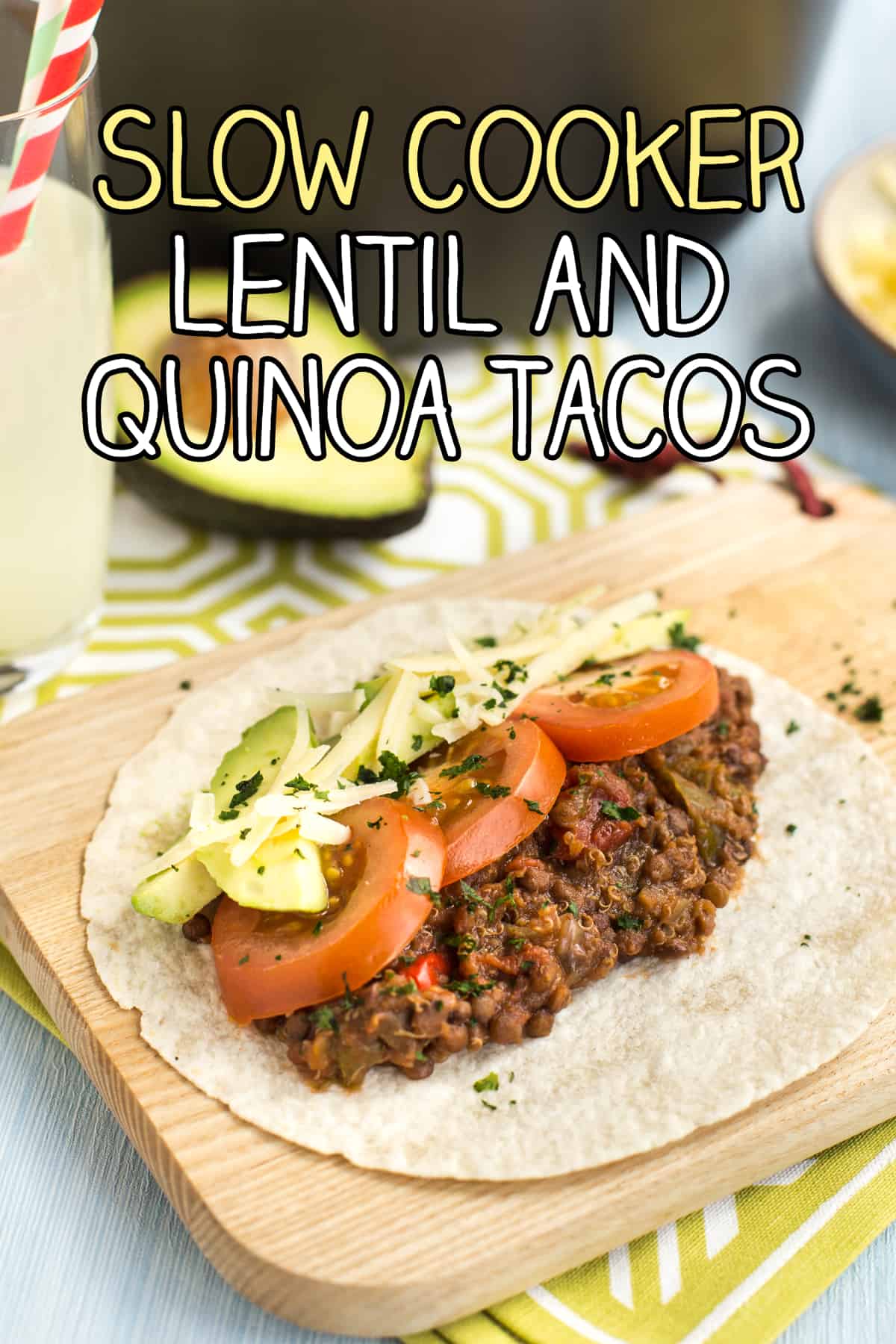 A lentil and quinoa taco topped with sliced tomato and avocado.