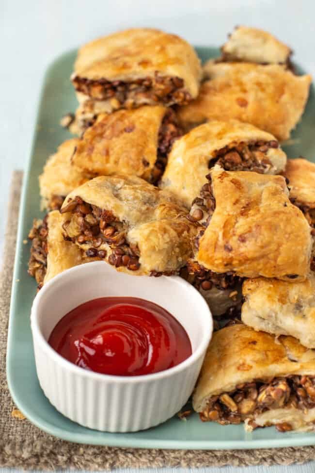 A pile of vegetarian sausage rolls on a plate.