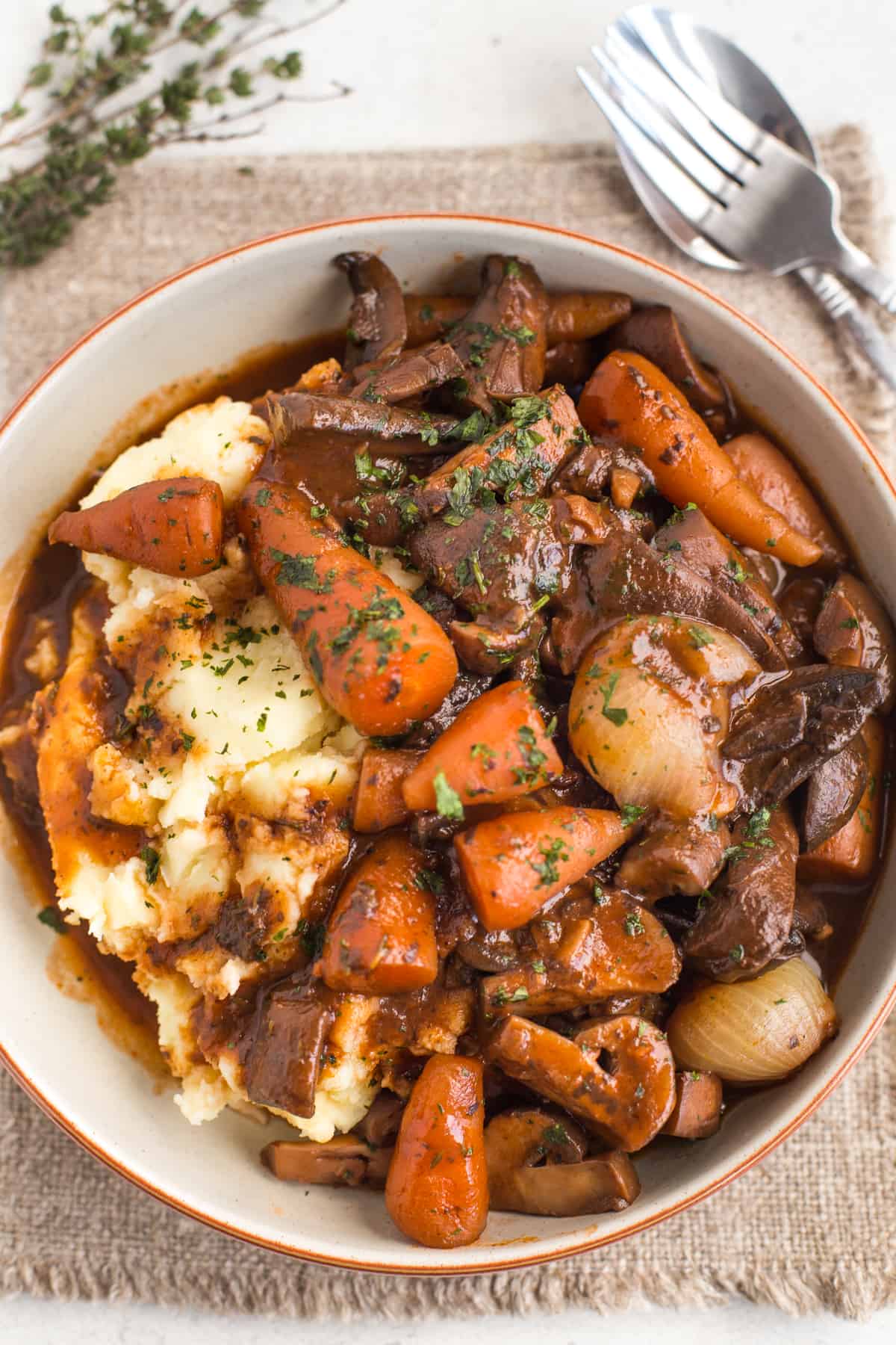 Vegetarian mushroom bourguignon in a bowl with mashed potato.