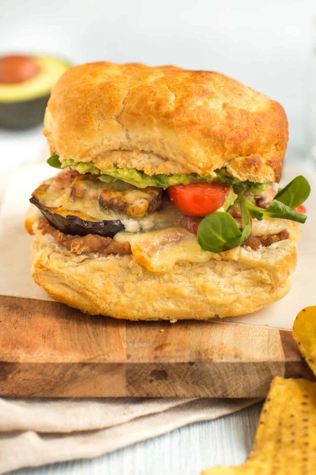 A vegetarian torta in a crusty roll, filled with cheesy roasted vegetables, refried beans and salad.
