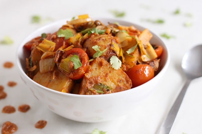 Roasted potato tikka masala - a super tasty side dish that's great hot or cold (with juicy roasted tomatoes, leeks and loads of fresh coriander!)