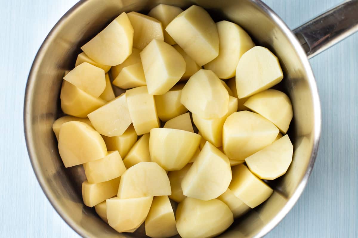Peeled and chopped potatoes in a large saucepan.