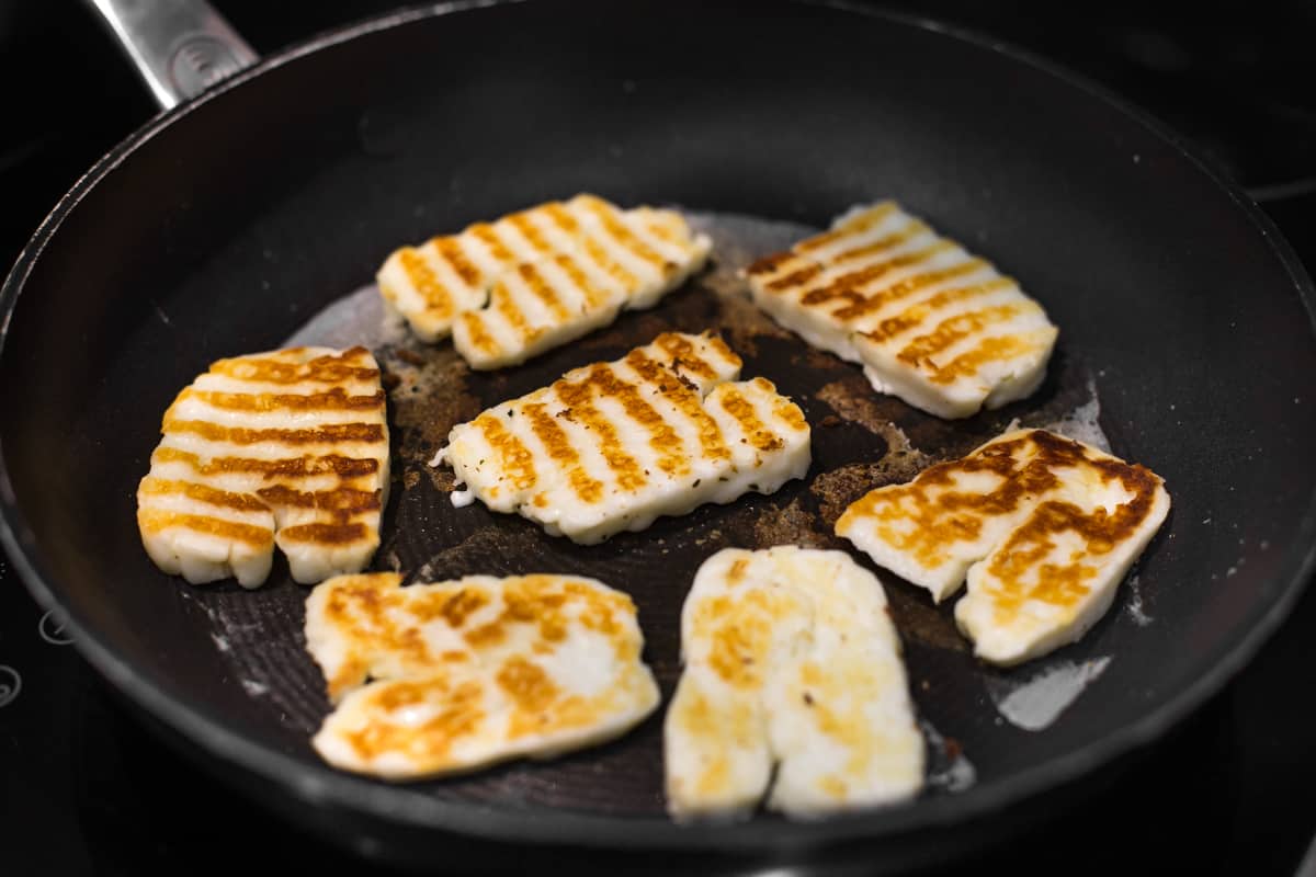 Slices of halloumi cheese with golden grill lines.