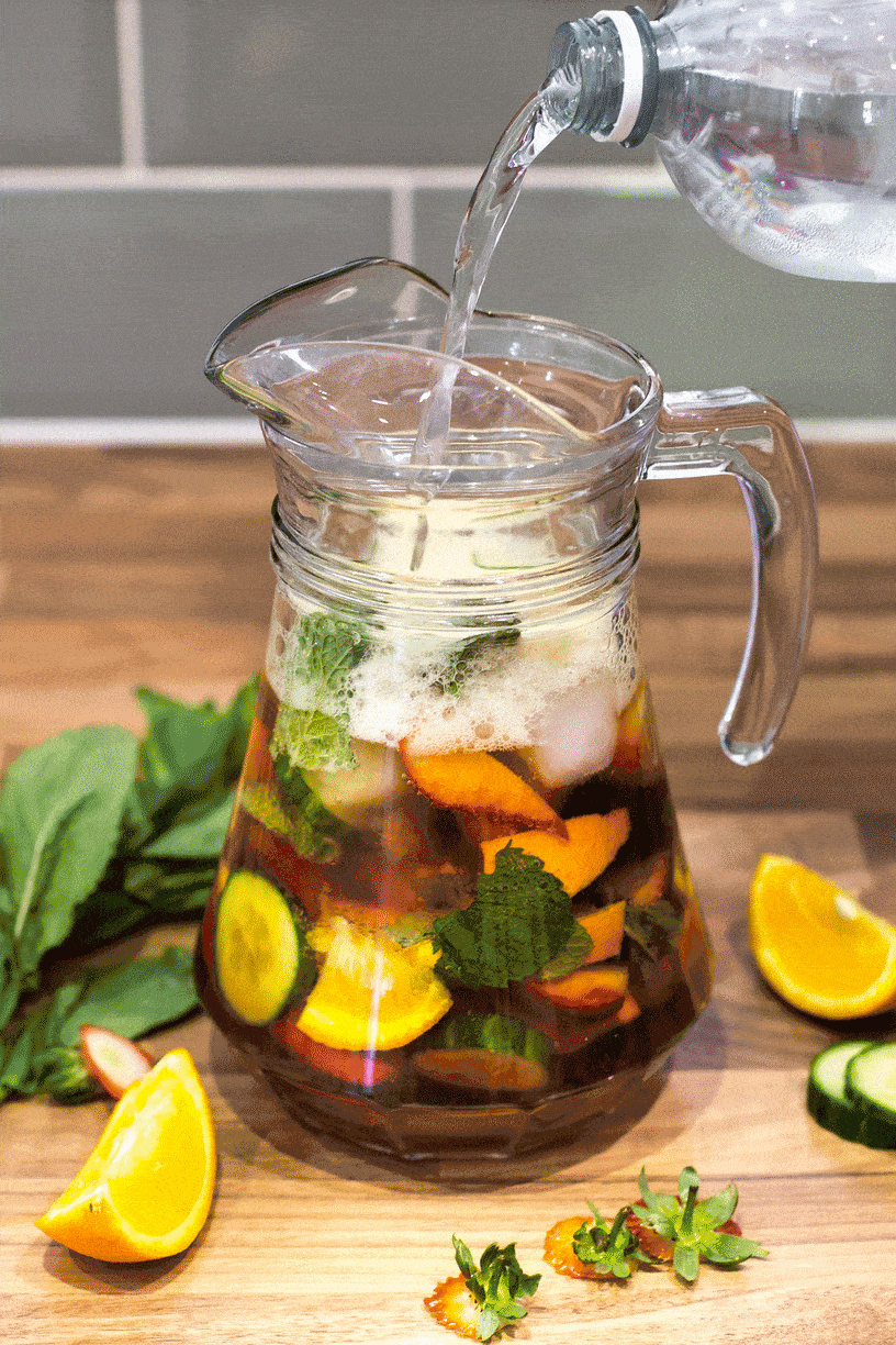 A GIF showing sparkling lemonade being poured over Pimm's in a jug.