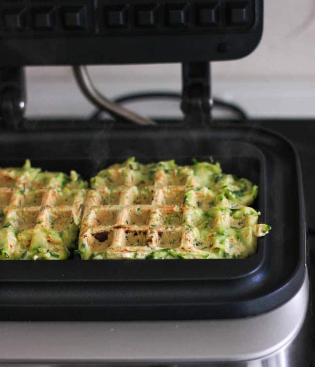 Courgette fritter waffles - a cross between a crispy zucchini fritter and a cakey waffle. So fun and delicious too!