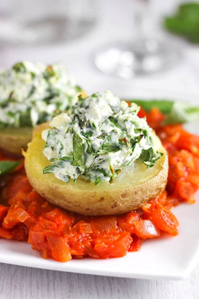 Spinach and ricotta stuffed potatoes, served on a rich tomato sauce. Why should potatoes always be served on the side? Make them the star of the show with this easy Italian-inspired dish. The crispy potatoes are so beautiful with the creamy ricotta topping!