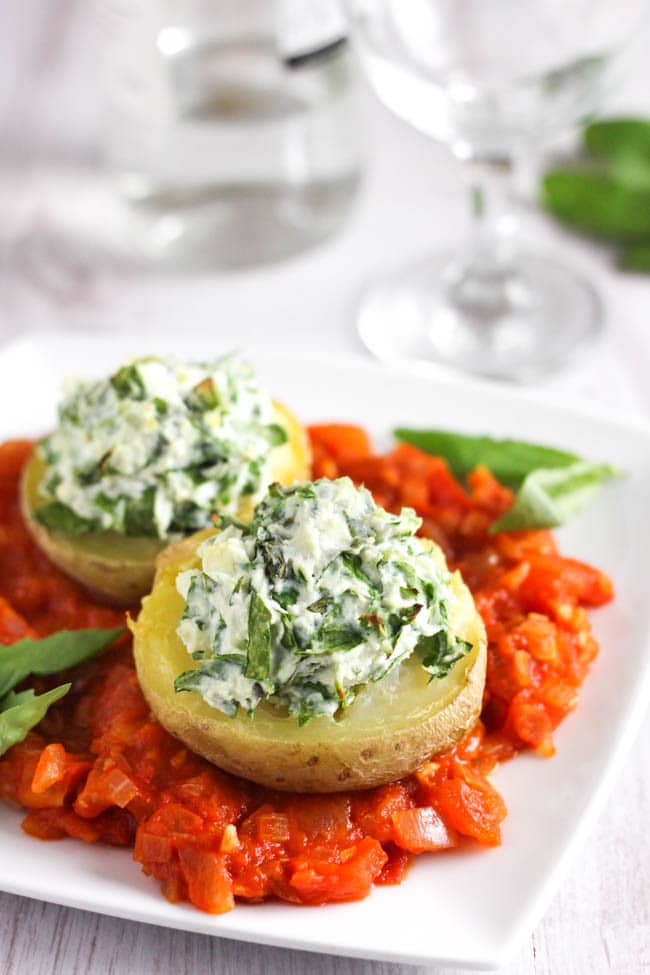 Spinach and ricotta stuffed potatoes, served on a rich tomato sauce. Why should potatoes always be served on the side? Make them the star of the show with this easy Italian-inspired dish. The crispy potatoes are so beautiful with the creamy ricotta topping!