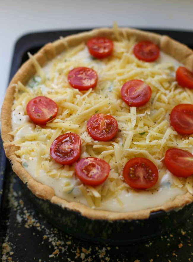 Cauliflower cheese tart - this irresistible tart combines a light and cheesy filling with juicy roasted tomatoes and flaky shortcrust pastry. A dreamy dinner party treat!