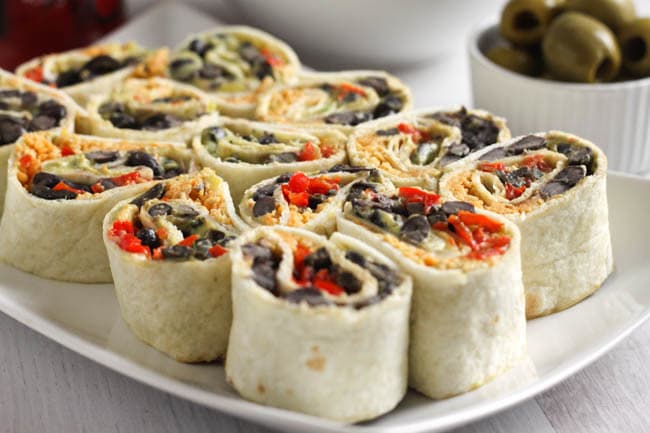Cheesy Tex Mex tortilla roll-ups - THESE ARE MY NEW FAVOURITE LUNCH EVER! They're creamy, cheesy, spicy, and just SO tasty. Great for a packed lunch, or to serve on a platter at a party! Definitely one I will revisit again and again :)
