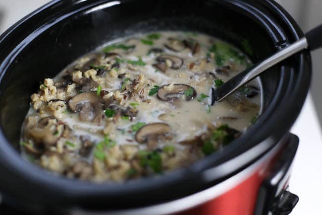 Slow cooker wild rice and mushroom soup - with garlic, parsley, cream, and white wine! This is DELICIOUS! And so easy too - just throw everything in the slow cooker for a simple but classy dinner!