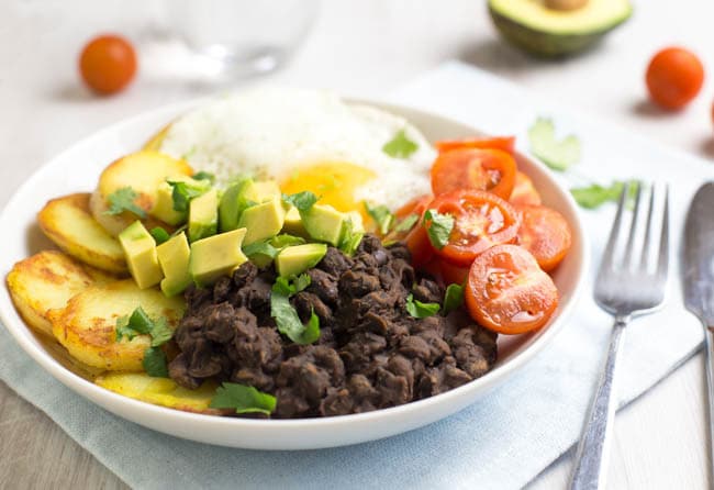 Smoky black bean breakfast bowls! Spicy chipotle black beans, served with crispy potatoes, a fried egg, and lots of fresh veggies - a brilliant way to start the day! Vegetarian, gluten-free, and easily made vegan.