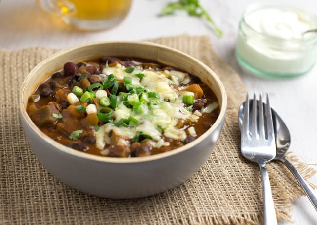 Vegetarian chilli in a bowl topped with cheese