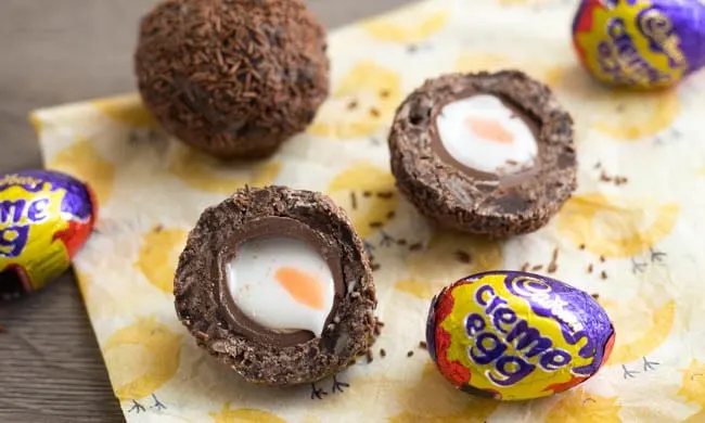 A Scotch Creme Egg cut in half, showing the gooey egg inside.