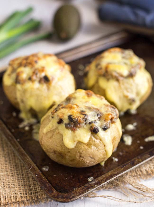 Mexican black bean stuffed potatoes - an easy way to make potatoes the star of the show! Stuffed with black beans and salsa, and topped with plenty of cheese. A fab vegetarian dinner!