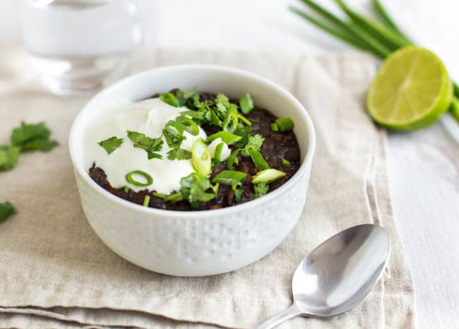 Black bean soup topped with sour cream, spring onions and fresh cilantro.