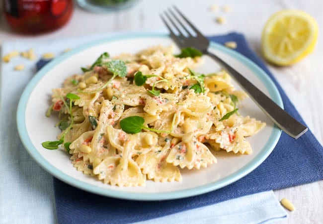 Creamy Peppadew pasta on a plate with a fork.