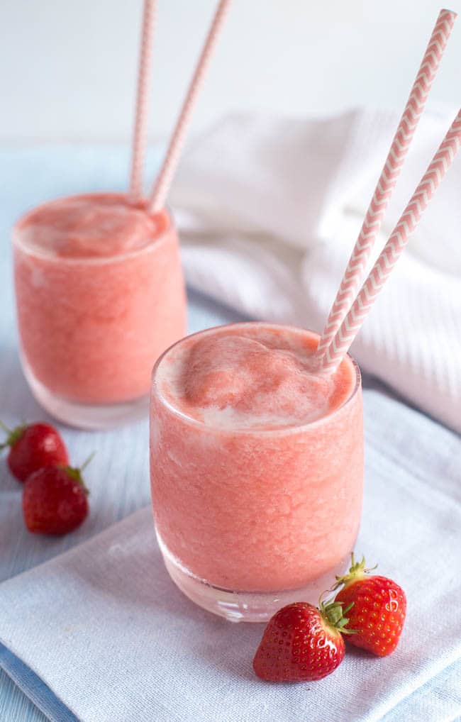 A creamy pink pina colada with fresh strawberries.