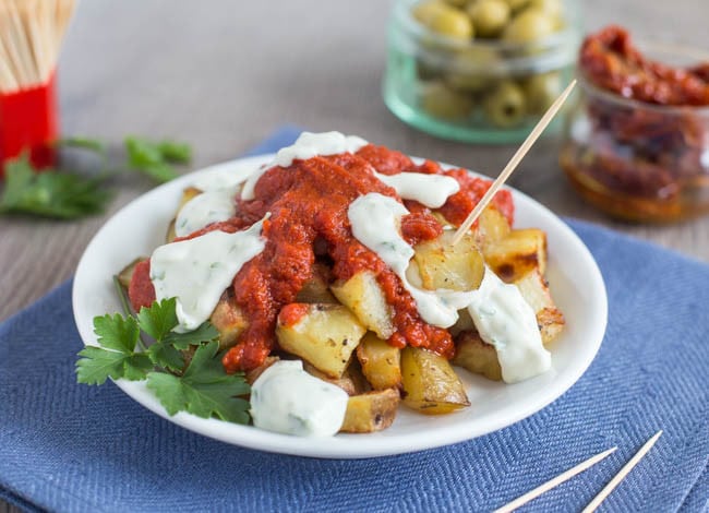Easy patatas bravas with garlic aioli - a simple version of the Spanish tapas. Crispy potatoes with a spicy tomato sauce and creamy garlic mayonnaise!