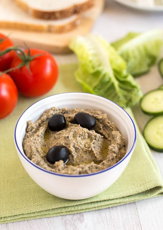 Homemade black olive hummus in a small bowl.