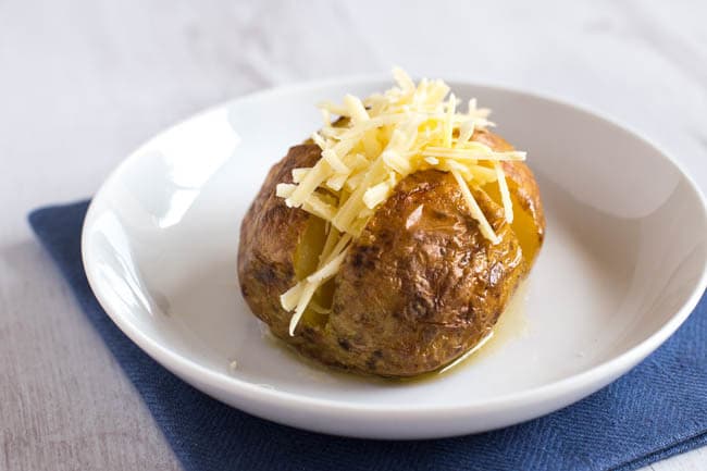 How to make the PERFECT baked potato! This method gives a soft and fluffy centre, with a crispy skin - and even includes a time-saving tip. My favourite method for making jacket potatoes!
