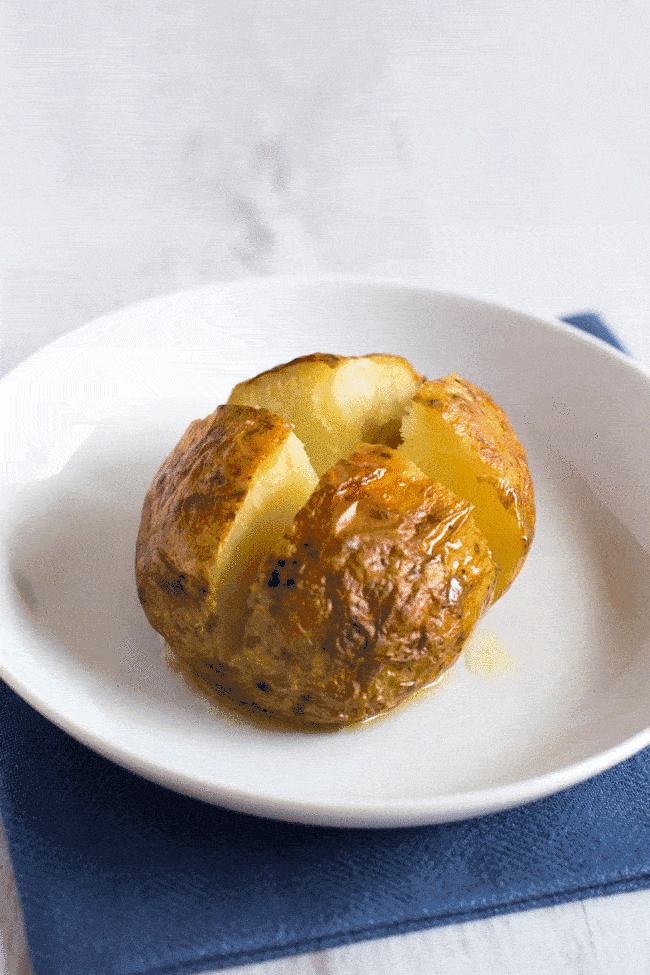A gif showing butter melting onto a baked potato.