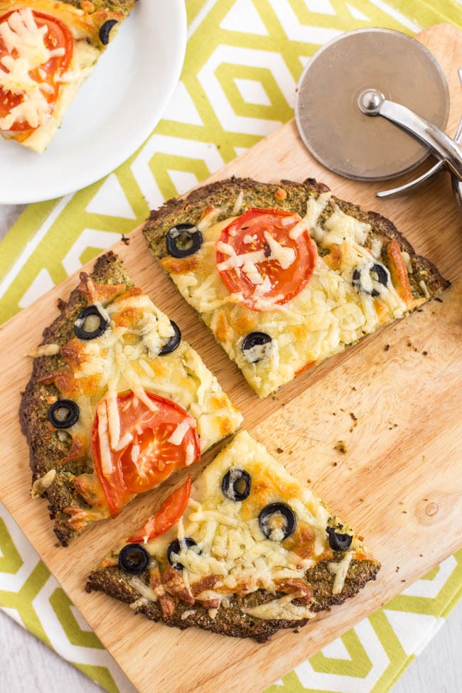 This low-carb broccoli pizza crust is so easy to make, and makes a brilliant alternative to a bread-heavy pizza! You can pick the slices up with your hands and everything! Gluten-free and vegetarian.
