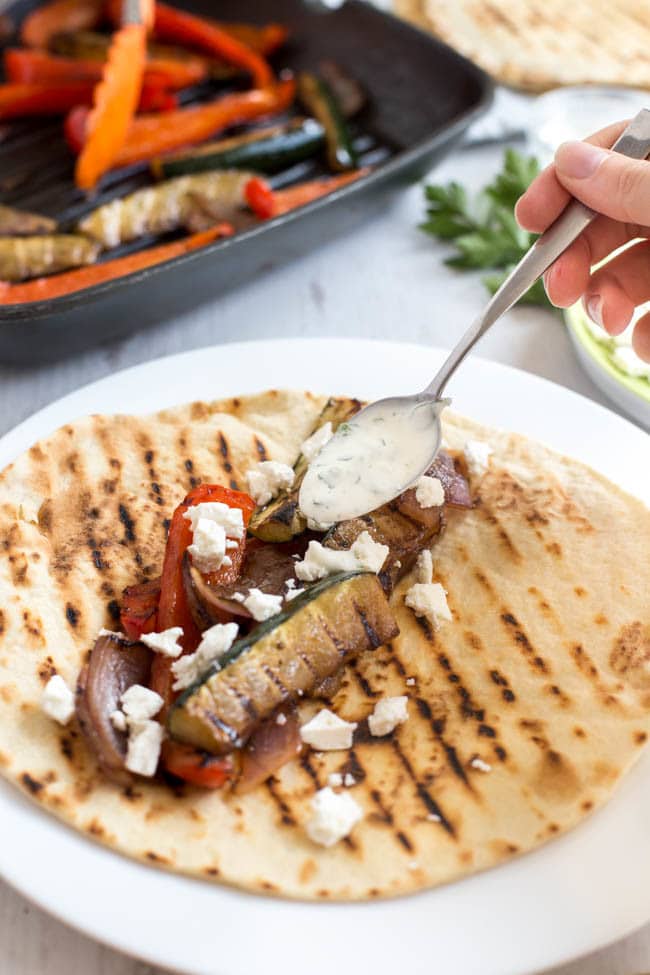 Easy vegetarian fajitas, made Mediterranean with balsamic vinegar, feta cheese and a herby yogurt dressing. Quick and delicious!