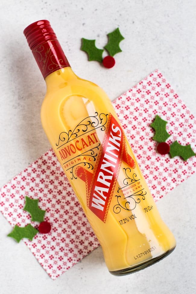 A bottle of Advocaat laying on a festive napkin.