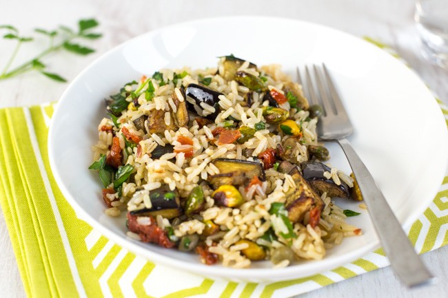 Warm brown rice salad with roasted aubergine and pistachios