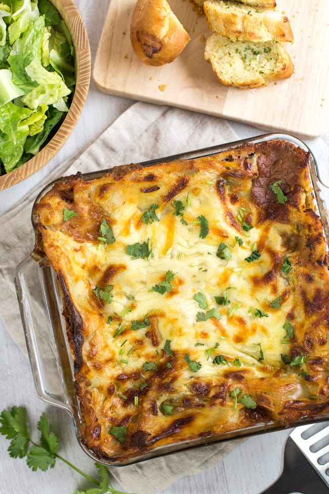 Mexican bean lasagne - a Mexican / Italian fusion that works so well! An easy vegetarian lasagne with spicy refried beans - yum!