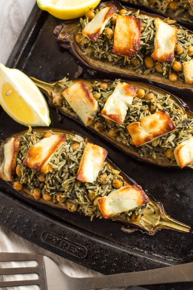 Stuffed aubergines with spinach rice and halloumi - the perfect vegetarian dinner to serve alongside a simple salad! The crispy halloumi on top really takes it to the next level.