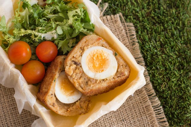 Vegetarian Scotch eggs - a veggie take on a British classic! Wrapped in a cheesy lentil mixture. Perfect for picnics and lunch boxes.