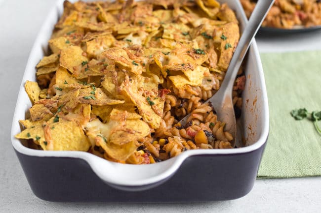 Nacho pasta bake - a creamy, spicy, vegetarian Mexican inspired pasta bake topped with tortilla chips and plenty of cheese!