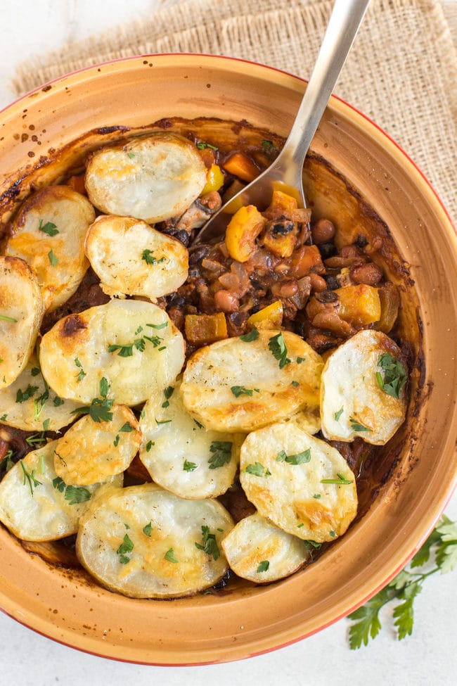 Spicy bean hotpot with crispy potato topping - the perfect healthy vegetarian comfort food! A spicy bean stew with lots of veggies and crispy, cheesy potatoes!