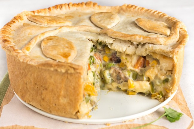 Creamy vegetable and halloumi pie with a slice removed
