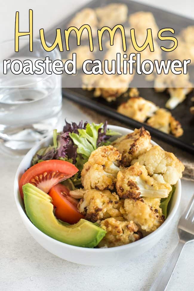 Hummus roasted cauliflower in a bowl with lettuce, tomato and avocado