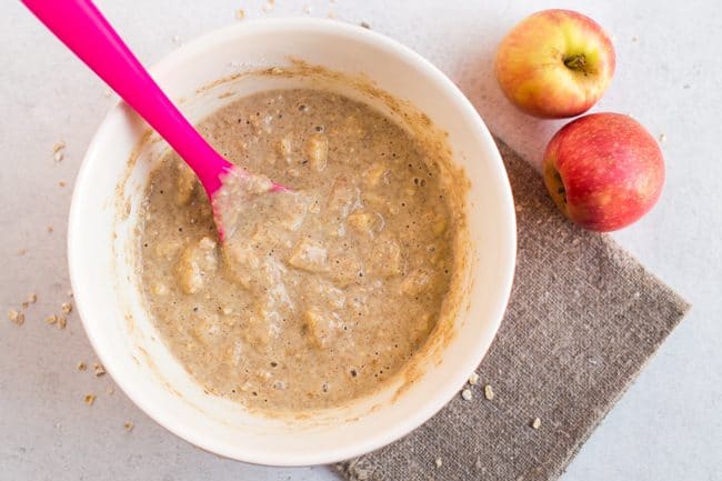 Uncooked mixture for apple and cinnamon breakfast muffins in a mixing bowl