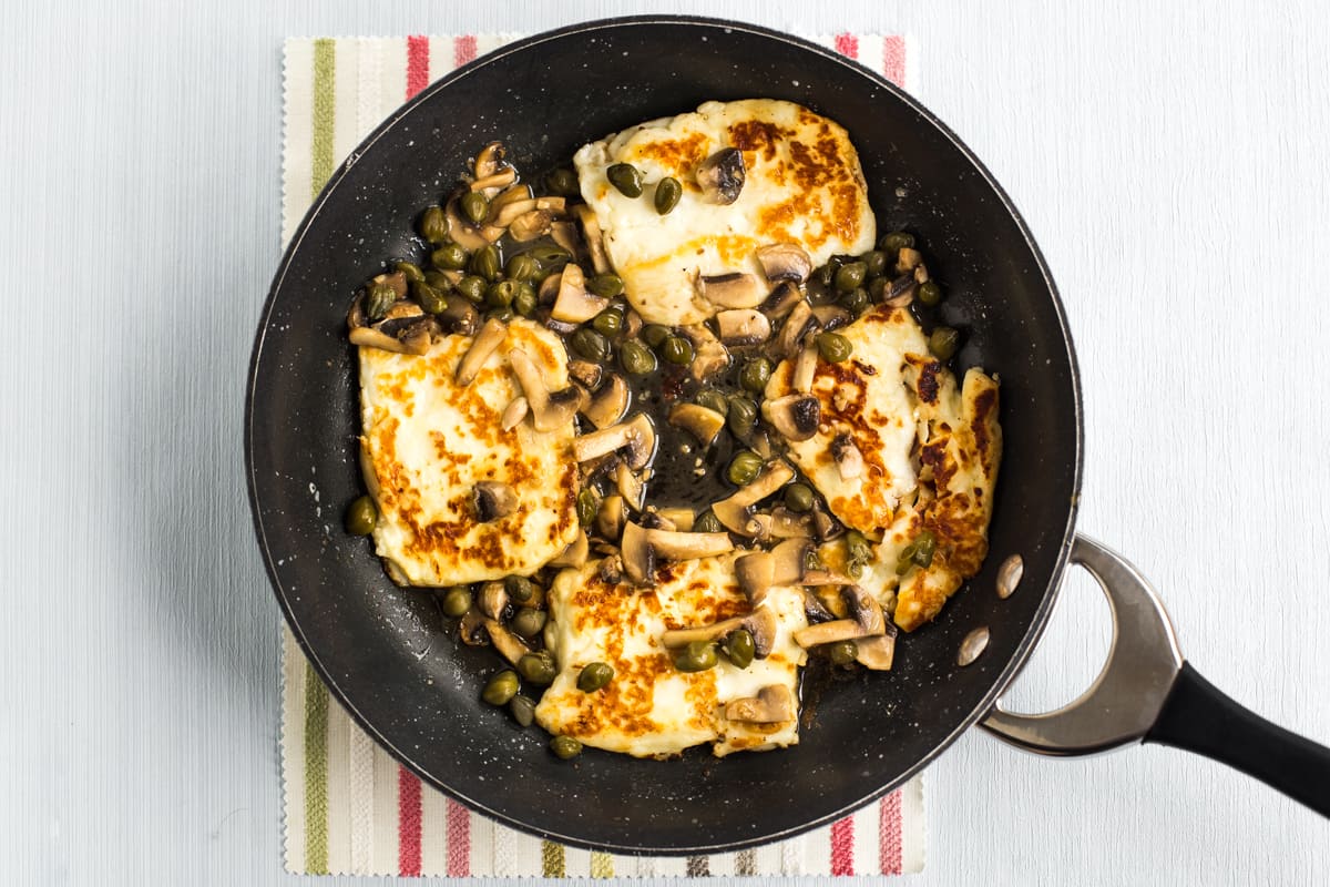 Halloumi piccata cooking in a frying pan