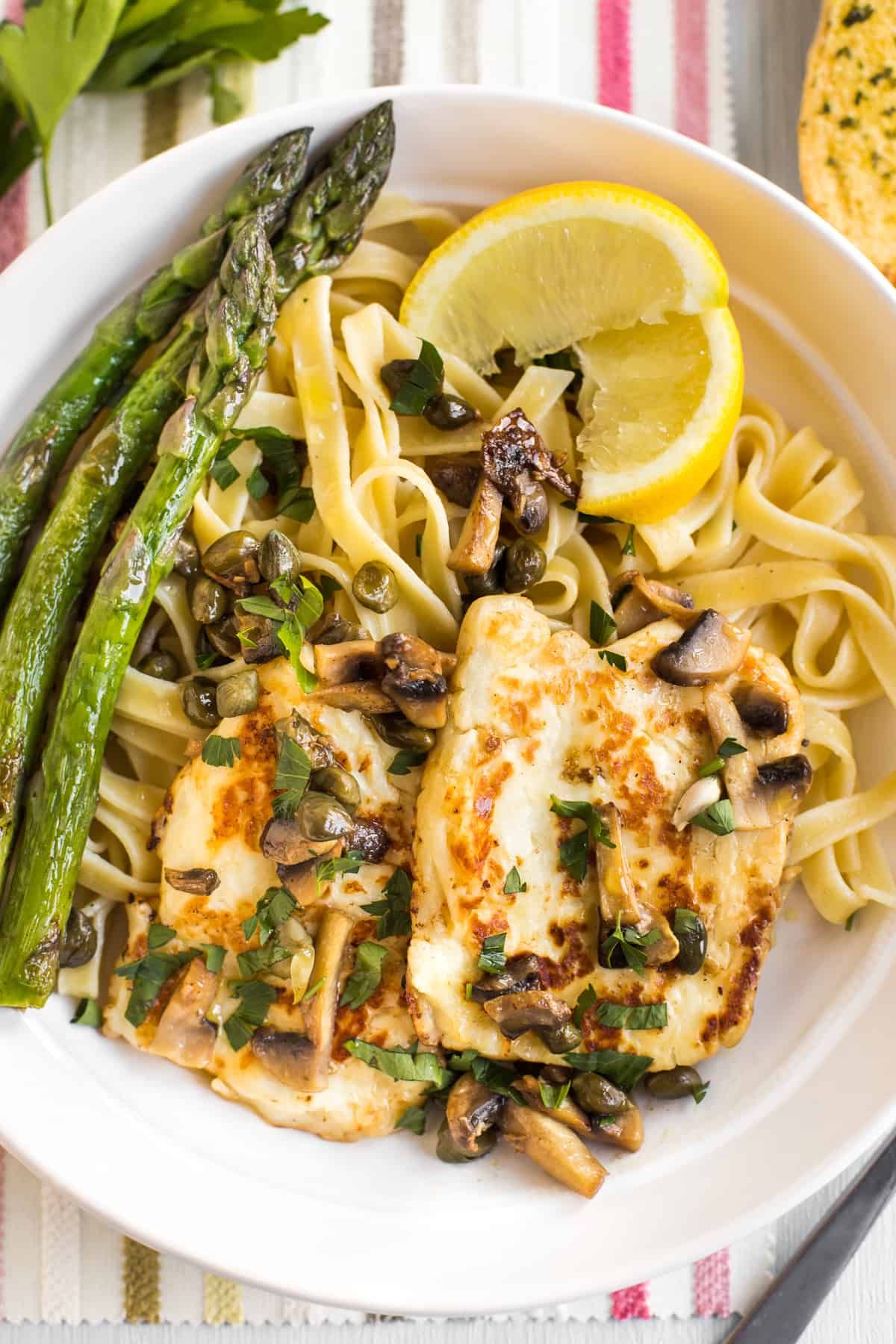 Portion of halloumi piccata served with tagliatelle and asparagus