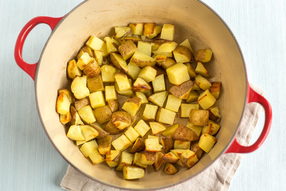 Potatoes roasting in a large casserole dish.