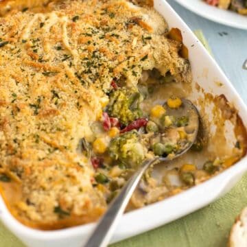 A creamy vegetable bake in a baking dish, with a scoop removed.