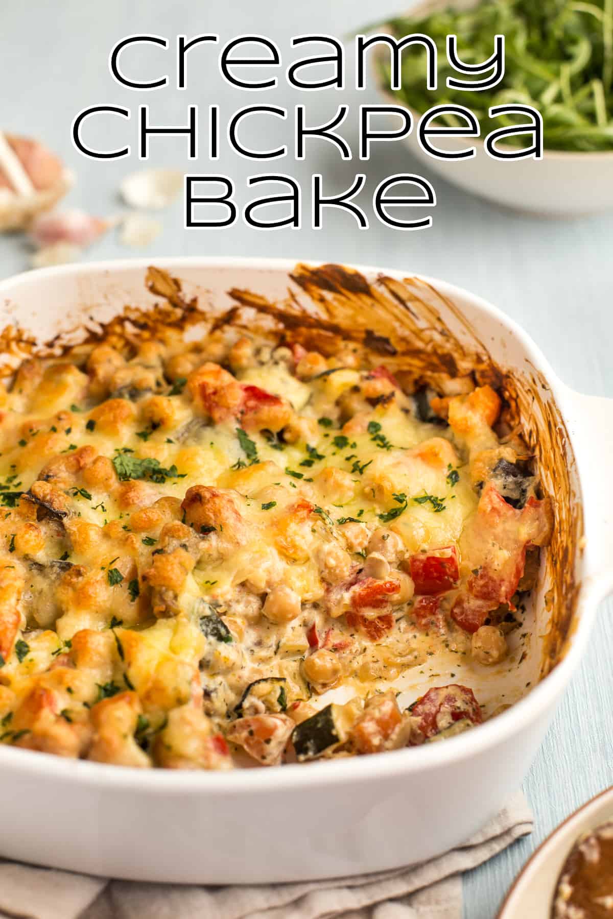 Creamy chickpea bake in a dish, with a scoop removed.