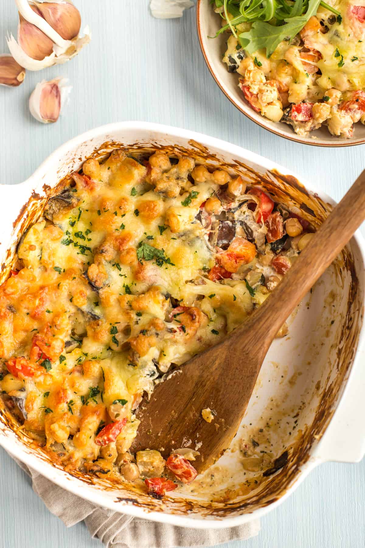 Creamy chickpea bake in a baking dish with a portion removed.